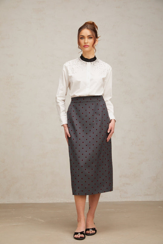 A white buttonup shirt adorned with sparkling crystal embellishments creating an elegant and glamorous look