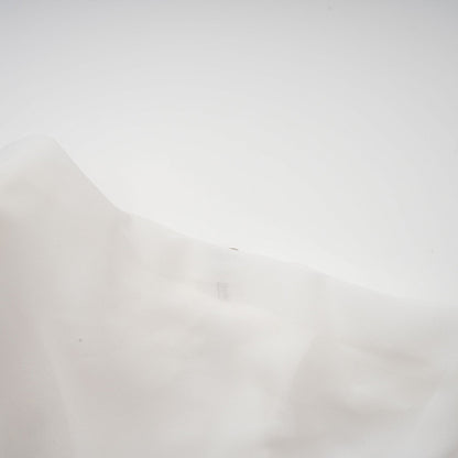 A white chiffon blouse with a flowy design named Jeanne