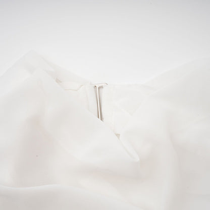A white chiffon blouse with a loose and flowing design named Jeanne