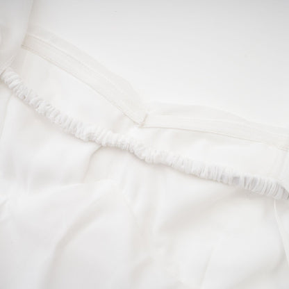 A white chiffon maxi dress with a halter neck and ruffle details named Mariah