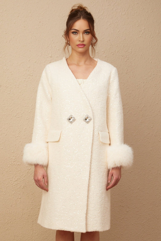 A white collarless coat made of textured fur fabric worn by a model against a plain background