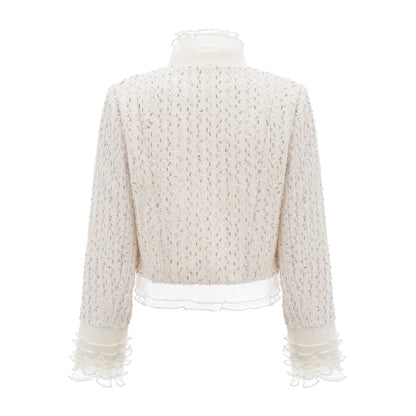 A white cropped jacket with beaded embellishments and ruffled details named Blanche