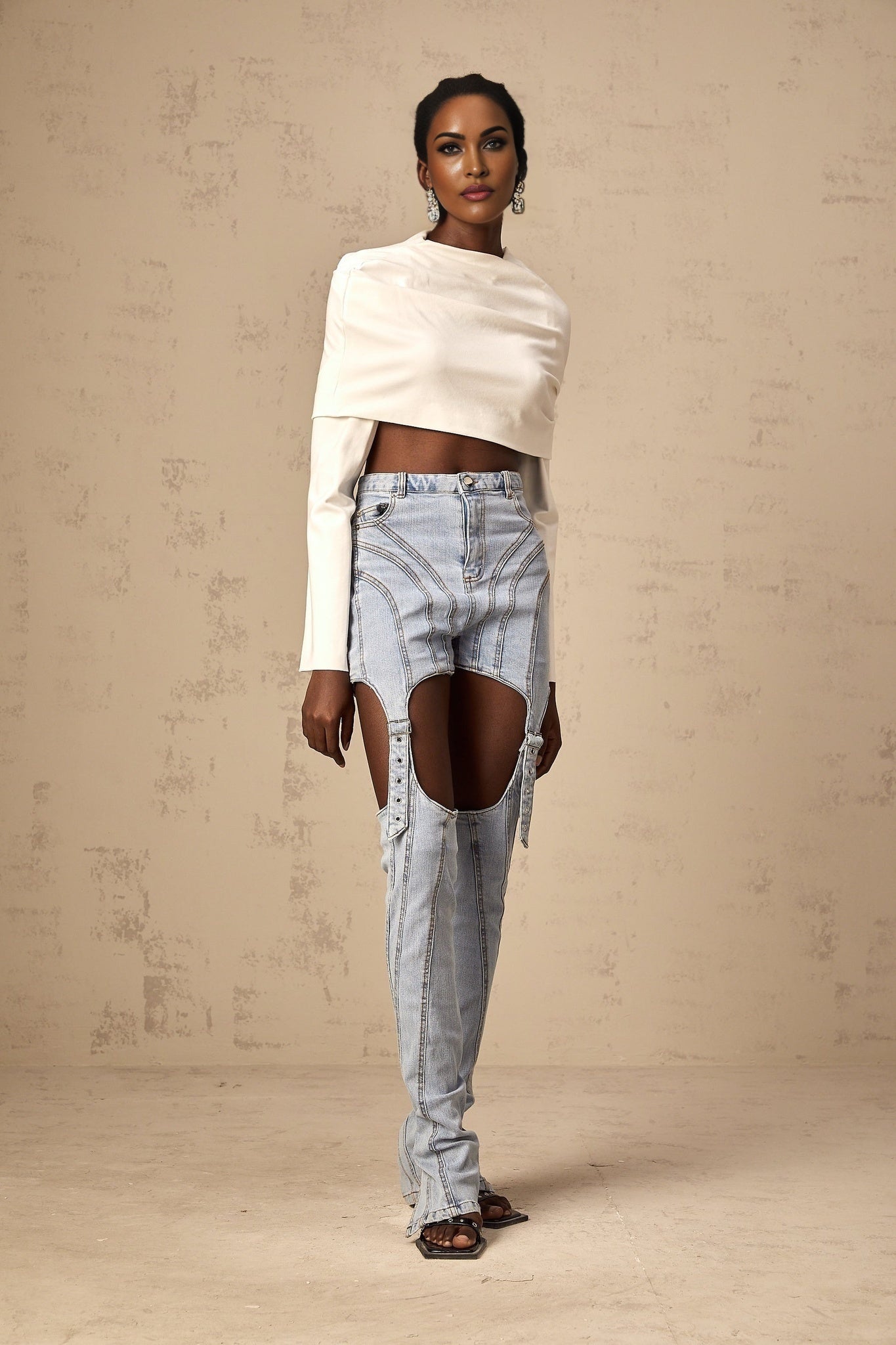 A white cropped top with ruched detailing named Hanna worn by a model against a plain background