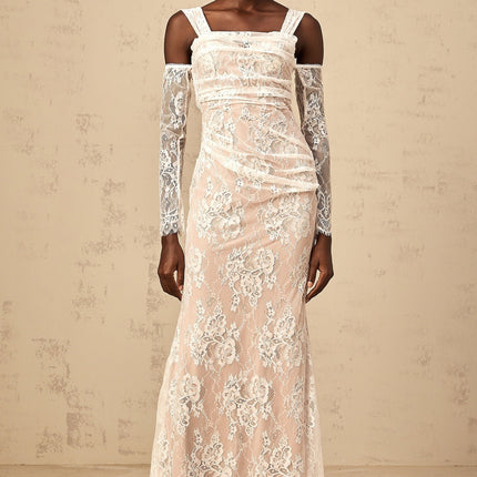A white floor length maxi dress with a corset style bodice featuring ruched floral lace detailing and thin straps
