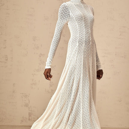 A white floorlength maxi dress with an allover wavy lace pattern featuring a fitted bodice and flowing skirt
