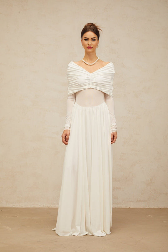A white floorlength maxi dress with draped details and ruching featuring a sleek silhouette and elegant design