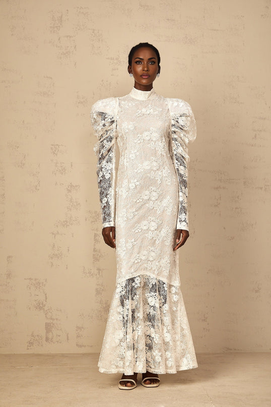 A white floorlength mermaid style dress with floral lace details and a fitted silhouette named Pauline