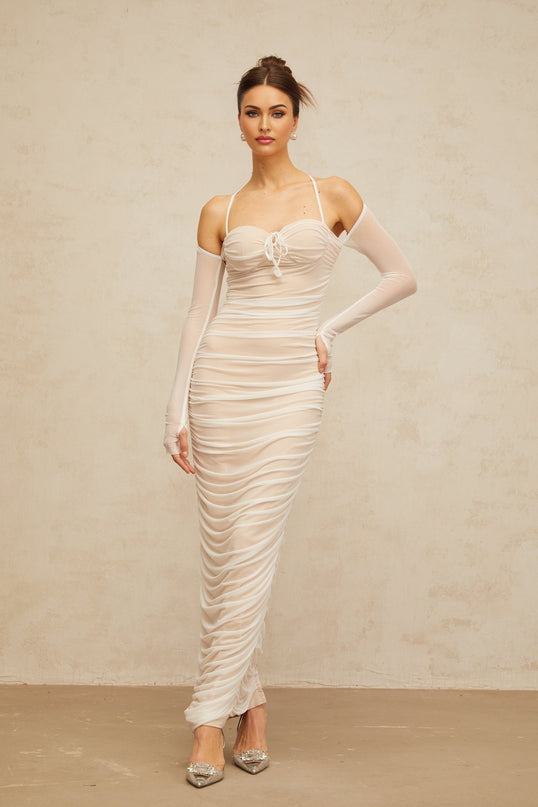 A white floorlength tulle dress with a ruched bustier top and flowing maxi skirt