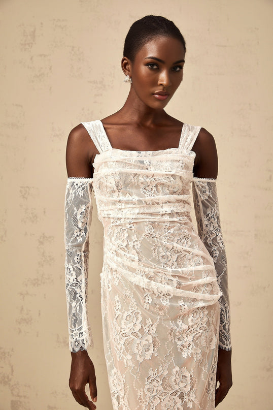 A white floral lace maxi dress with a corset style bodice and ruched detailing named Berenice