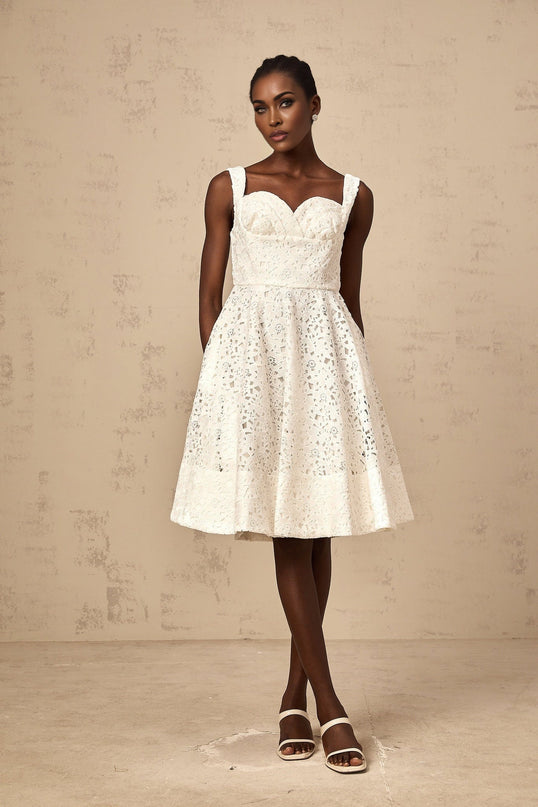 A white floral lace midi dress with delicate patterns and intricate details named Nicolette