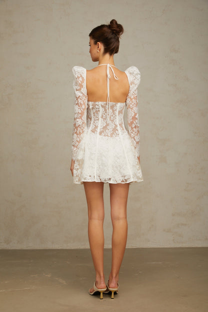 A white floral lace mini dress with a corset style bodice featuring a sweetheart neckline and short skirt