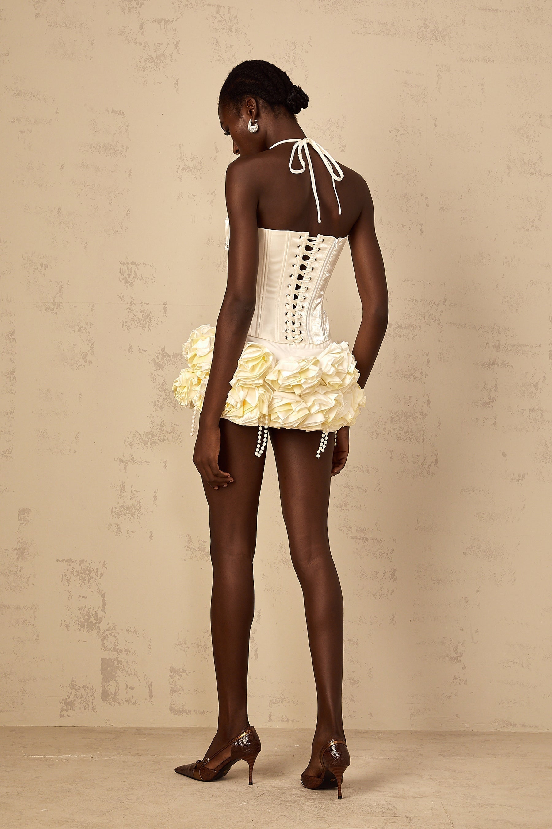 A white floral patterned matching set featuring a corset top and skirt with a Madeleine style design