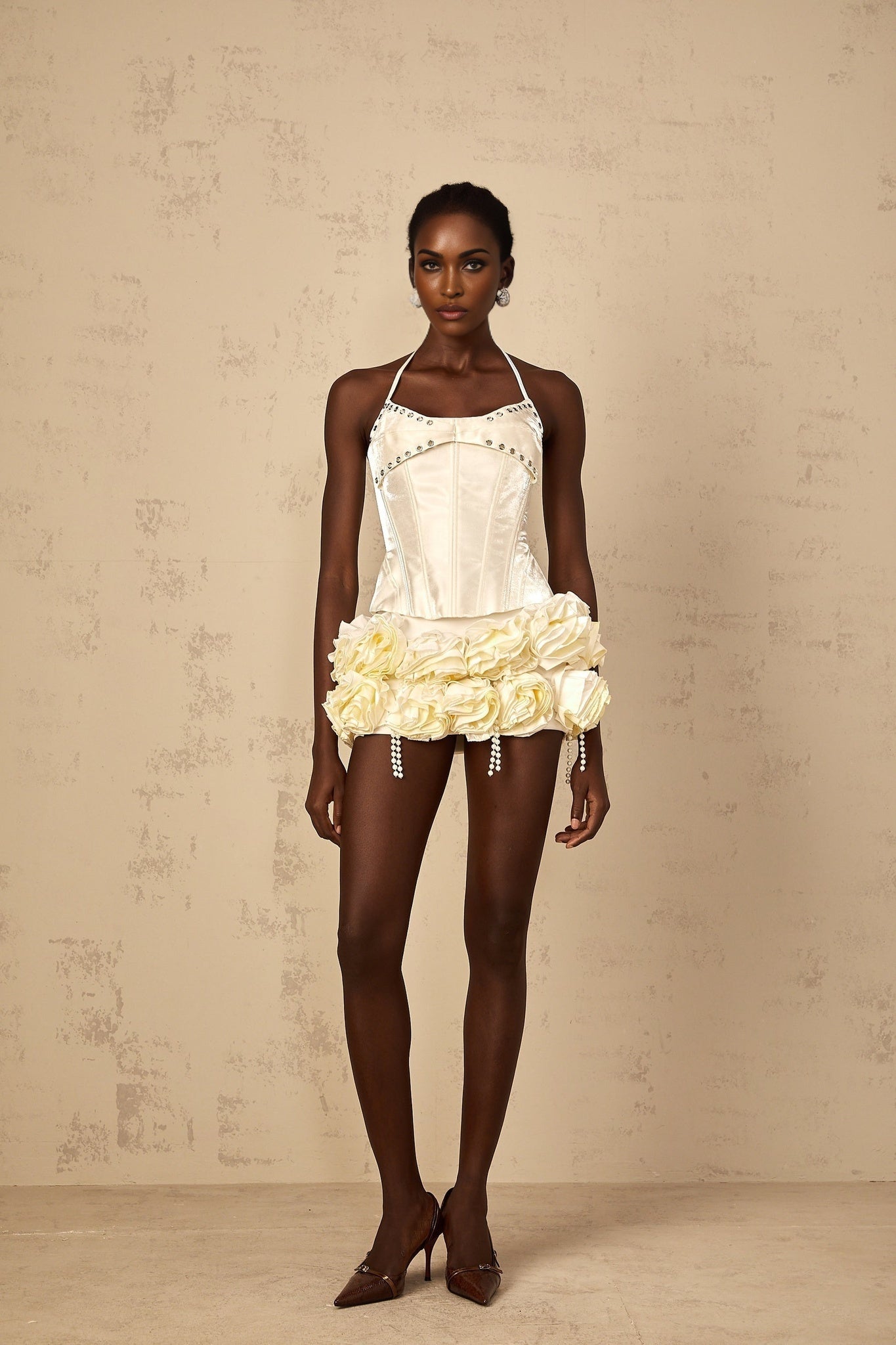 A white floral patterned matching set featuring a corset top and skirt with a Madeleine style design
