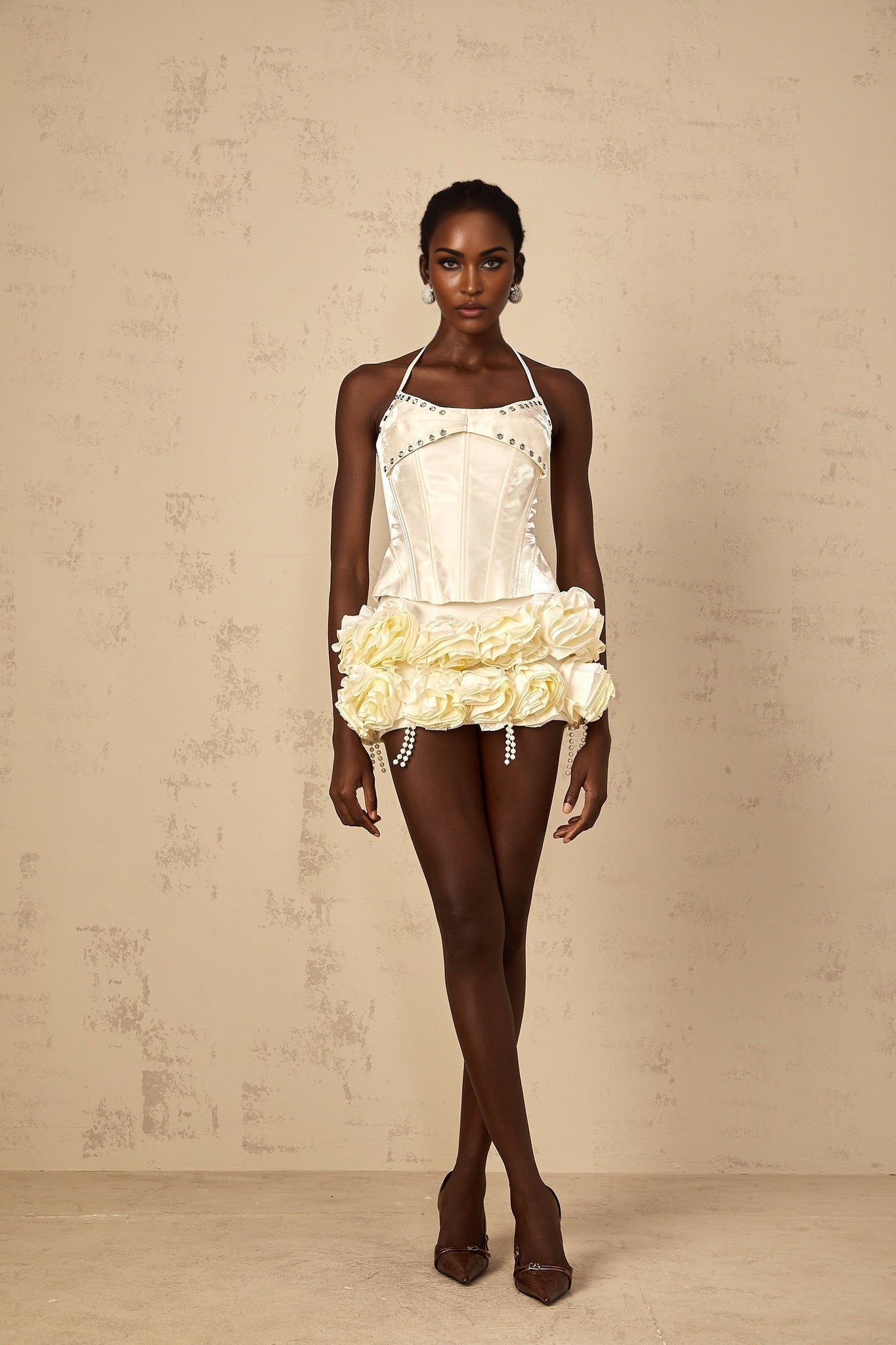 A white floral patterned matching set featuring a corset top and skirt with a Madeleine style design