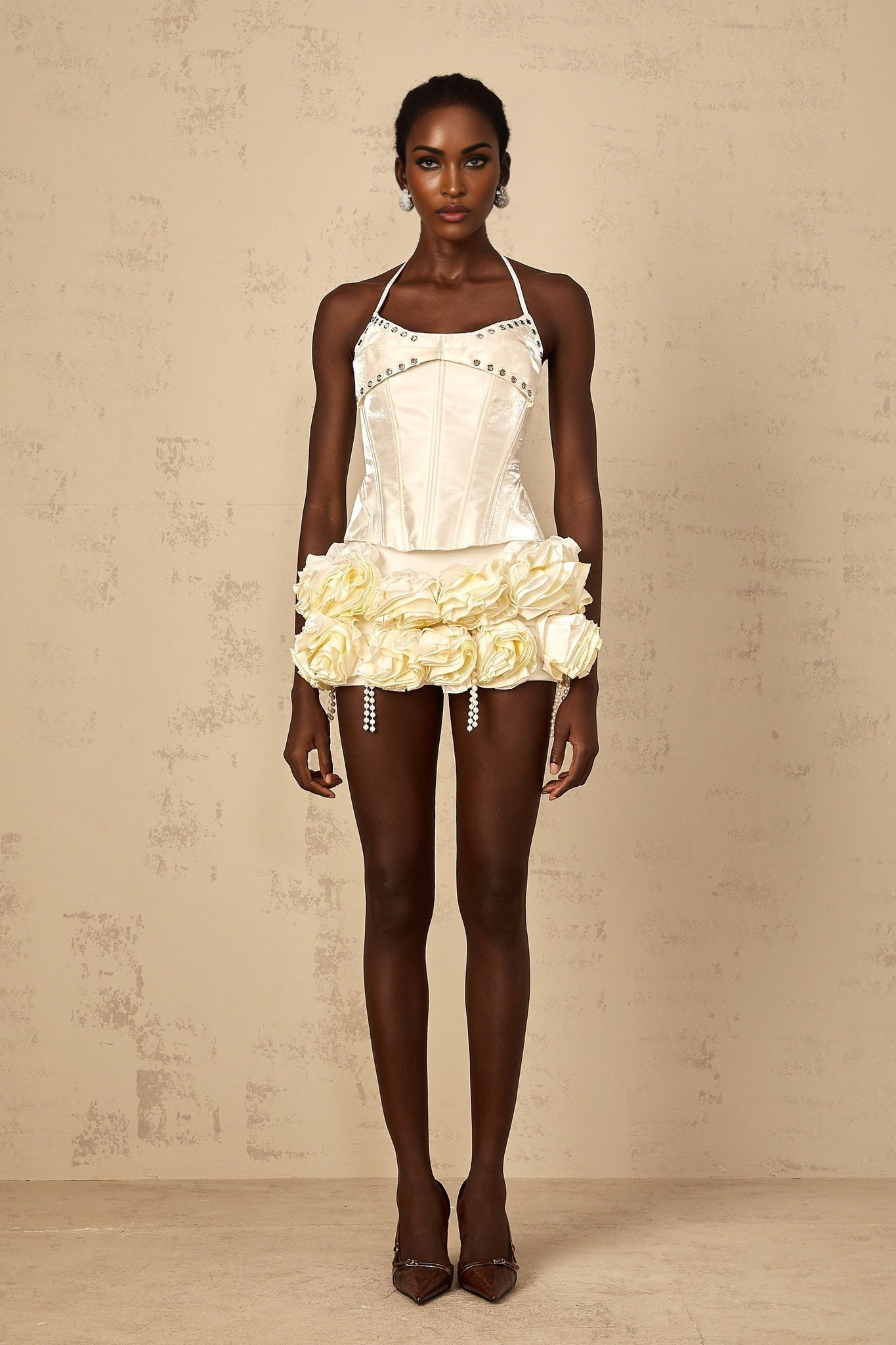 A white floral print matching set featuring a corset top and skirt with Madeleine style design on a light background