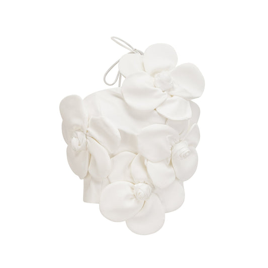A white halterneck top with colorful floral appliqué details along the neckline and bodice