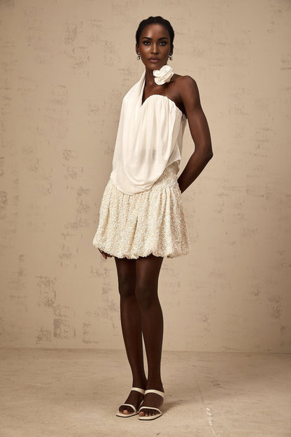 A white halterneck top with floral appliques called Maeva
