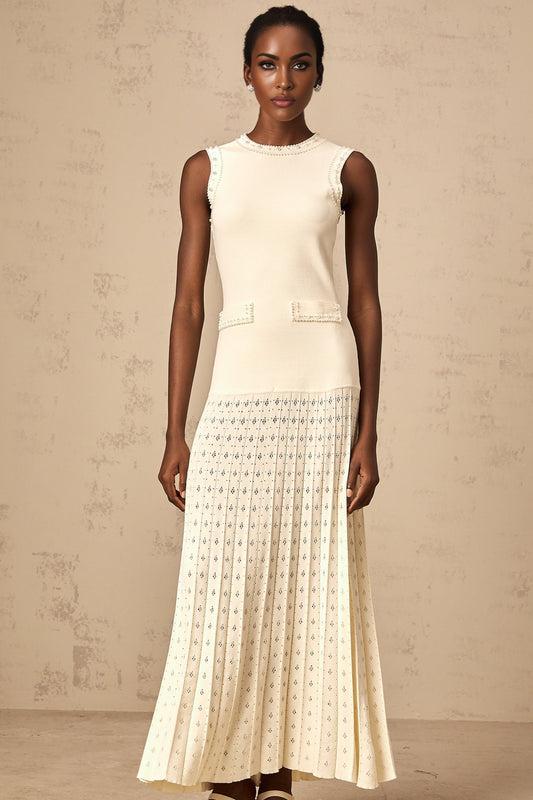 A white knitted maxi dress with faux pearl embellishments by Donatienne