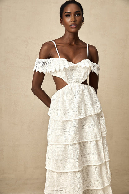 A white lace midi dress with openwork details named Genevieve on a plain background