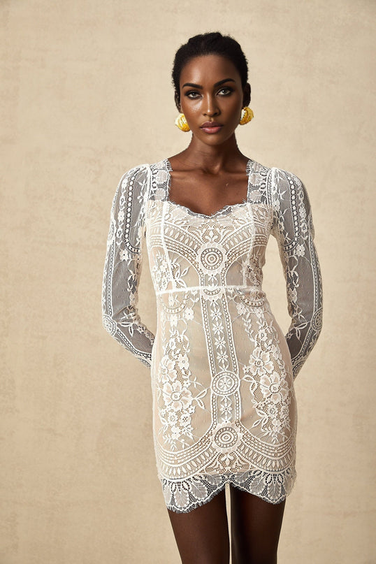 A white lace mini dress with scalloped hem and delicate floral pattern