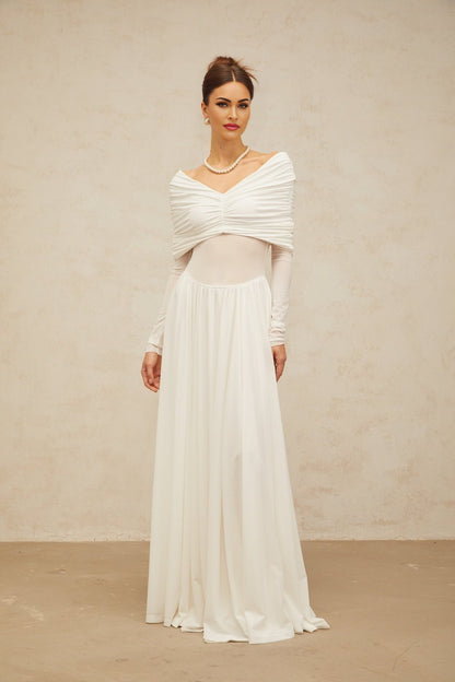 A white long maxi dress with ruched detailing and draped elements on a female model