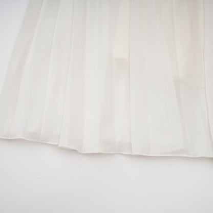 A white matching set featuring a pleated jacket and dress with embellishments The jacket has long sleeves and the dress has a fitted silhouette Both pieces are adorned with delicate embroidery or beadwork creating an elegant ensemble