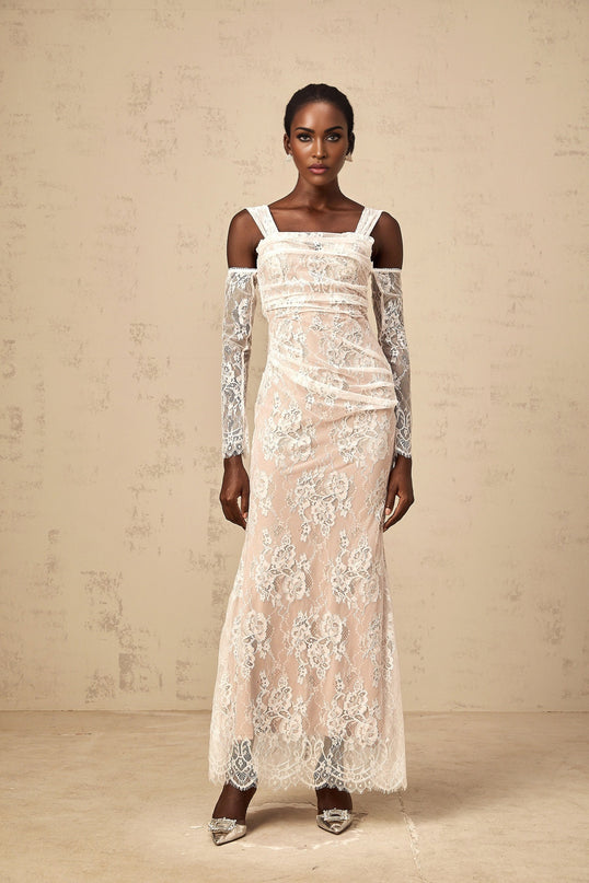 A white maxi dress featuring a floral lace corset bodice with ruched detailing and a flowing skirt