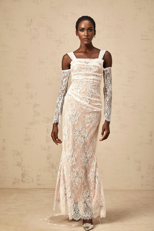 A white maxi dress with a corset bodice made of floral lace featuring ruched details and a long flowing skirt named Berenice