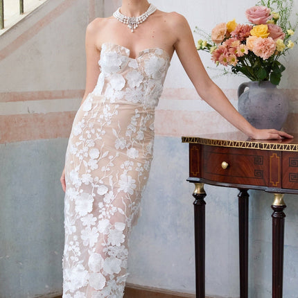 A white maxi dress with floral applique details and a corsetstyle bodice named Brigitte