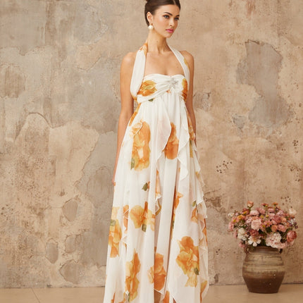 A white maxi dress with floral print and ruffled tulle details featuring a flowing design and feminine silhouette