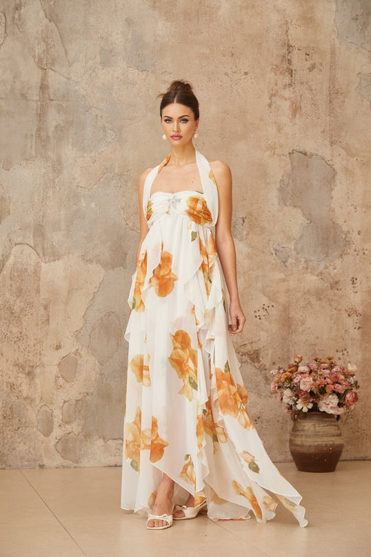 A white maxi dress with floral print featuring ruffled tulle details and a flowing silhouette