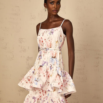 A white maxi dress with floral print pattern featuring ruffled tiers and a long flowing skirt
