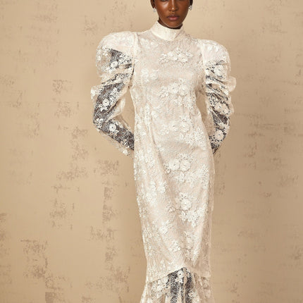 A white mermaid style maxi dress with floral lace detailing named Pauline featuring a fitted bodice and flared skirt