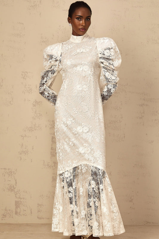 A white mermaid style maxi dress with floral lace pattern featuring a fitted bodice and flared skirt named Pauline