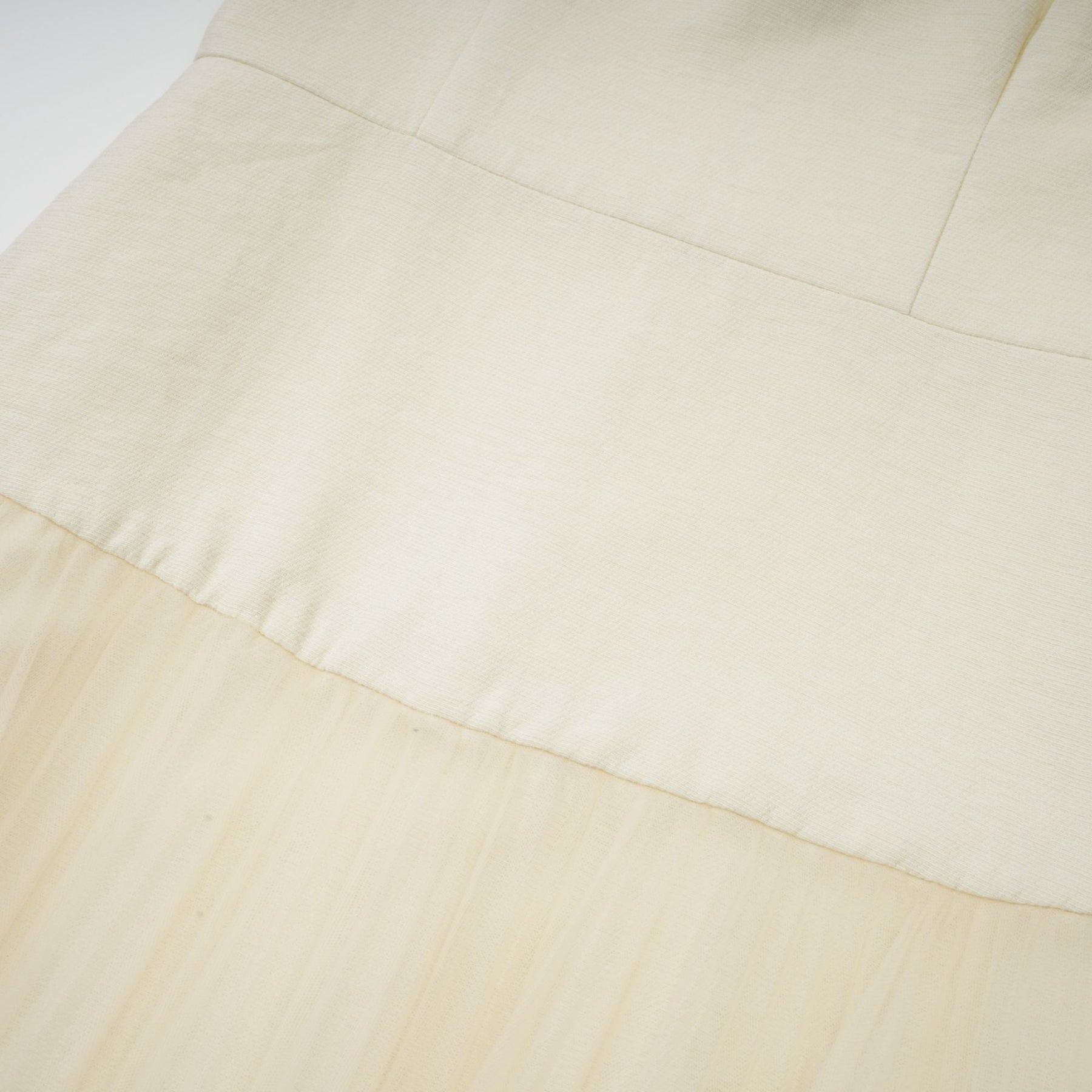 A white midi dress featuring a bowknot detail and tulle paneling named Therese