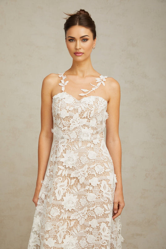 A white midi dress featuring lace detailing and tulle panels with a feminine silhouette named Carole