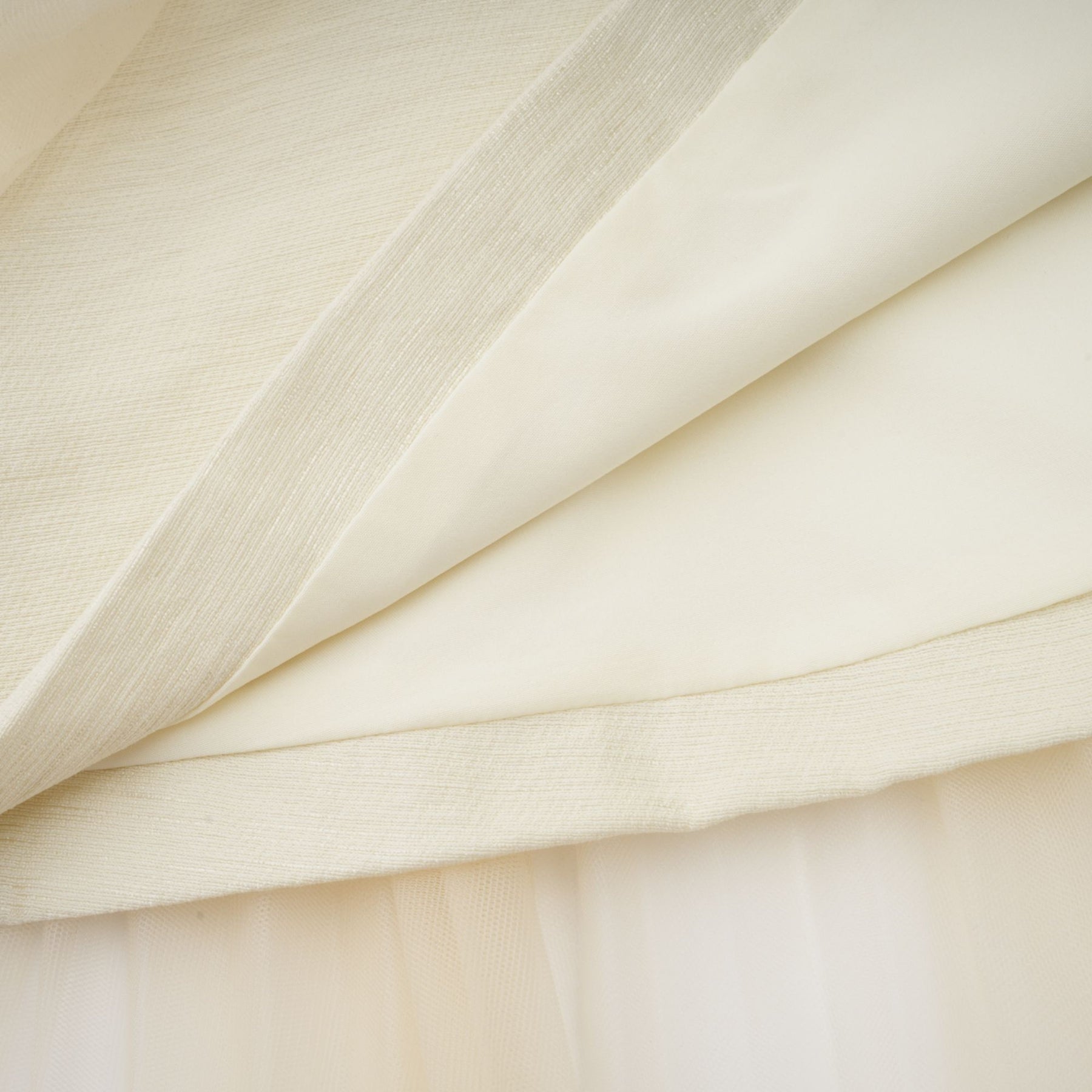 A white midi dress with a bow detail and tulle panels named Therese