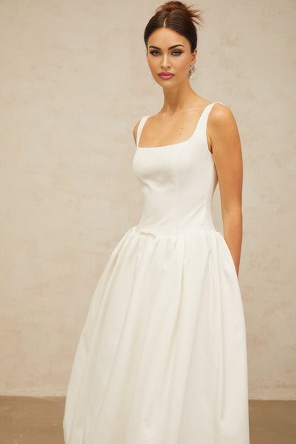 A white midi dress with a bowknot detail and flounced design named Perrine
