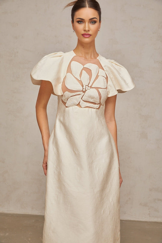 A white midi dress with a floral jacquard pattern featuring a feminine silhouette and delicate flower design throughout the fabric