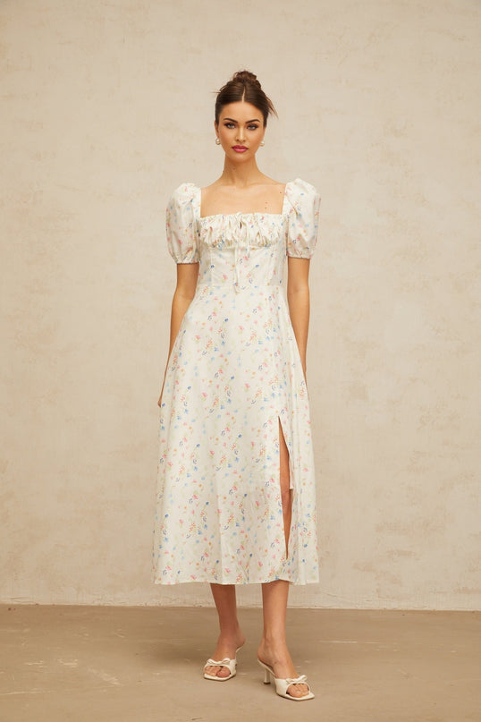 A white midi dress with a floral print pattern and flared skirt silhouette