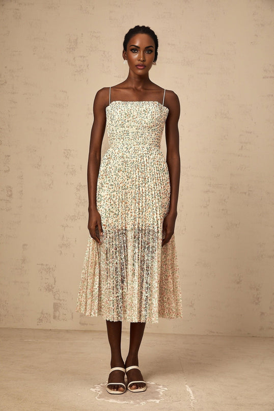 A white midi dress with a floral print pattern featuring pleats and a Marion design