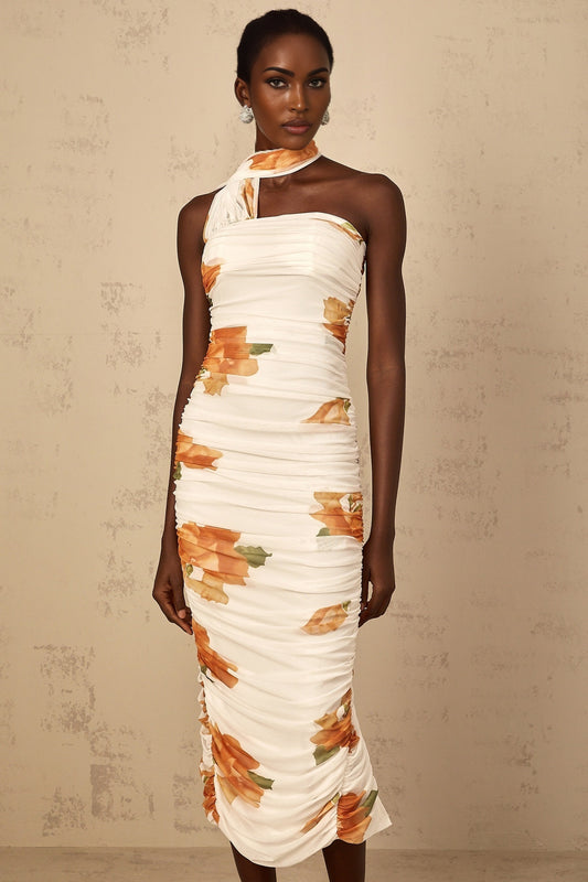 A white midi dress with a floral print pattern made of ruched tulle fabric featuring a Frida design