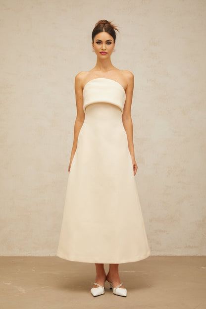 A white midi dress with a folded corset bodice and a fitted silhouette named Raphaelle