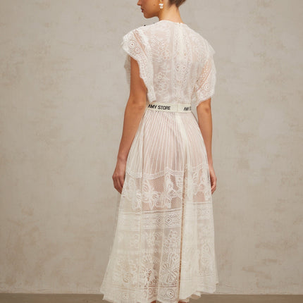 A white midi dress with a jacquard floral lace pattern featuring pleats and a fit and flare silhouette named Phoebe