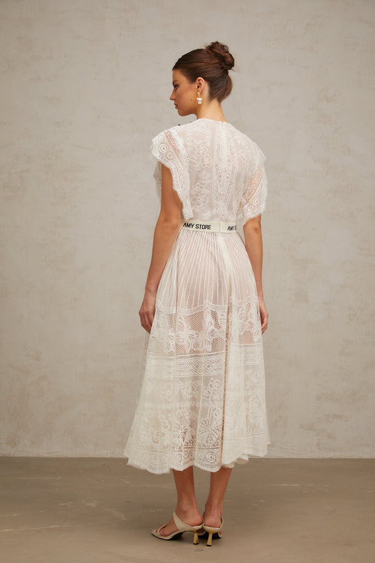 A white midi dress with a jacquard floral lace pattern featuring pleats and a fit and flare silhouette named Phoebe