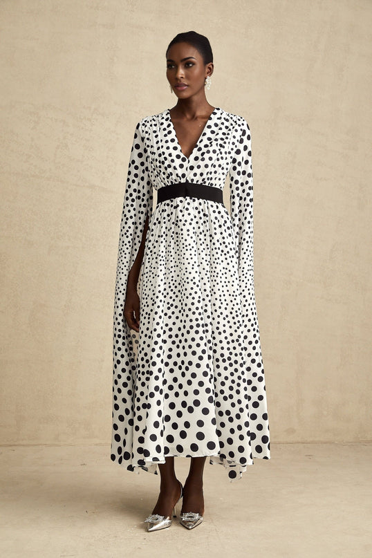 A white midi dress with black polka dots and slit sleeves named Brigitte