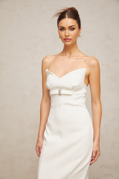 A white midi dress with corsetstyle bodice and bow detail named Isaline