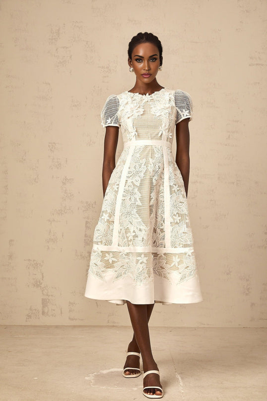 A white midi dress with floral embroidery details named Clémence