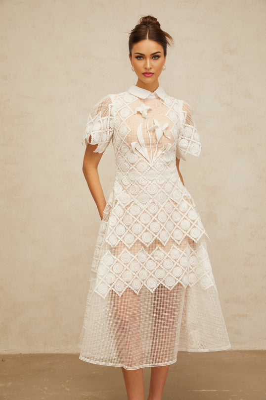 A white midi dress with floral embroidery details named Yasmine