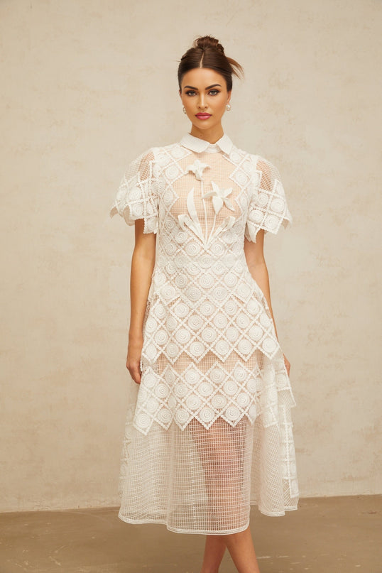A white midi dress with floral embroidery details named Yasmine